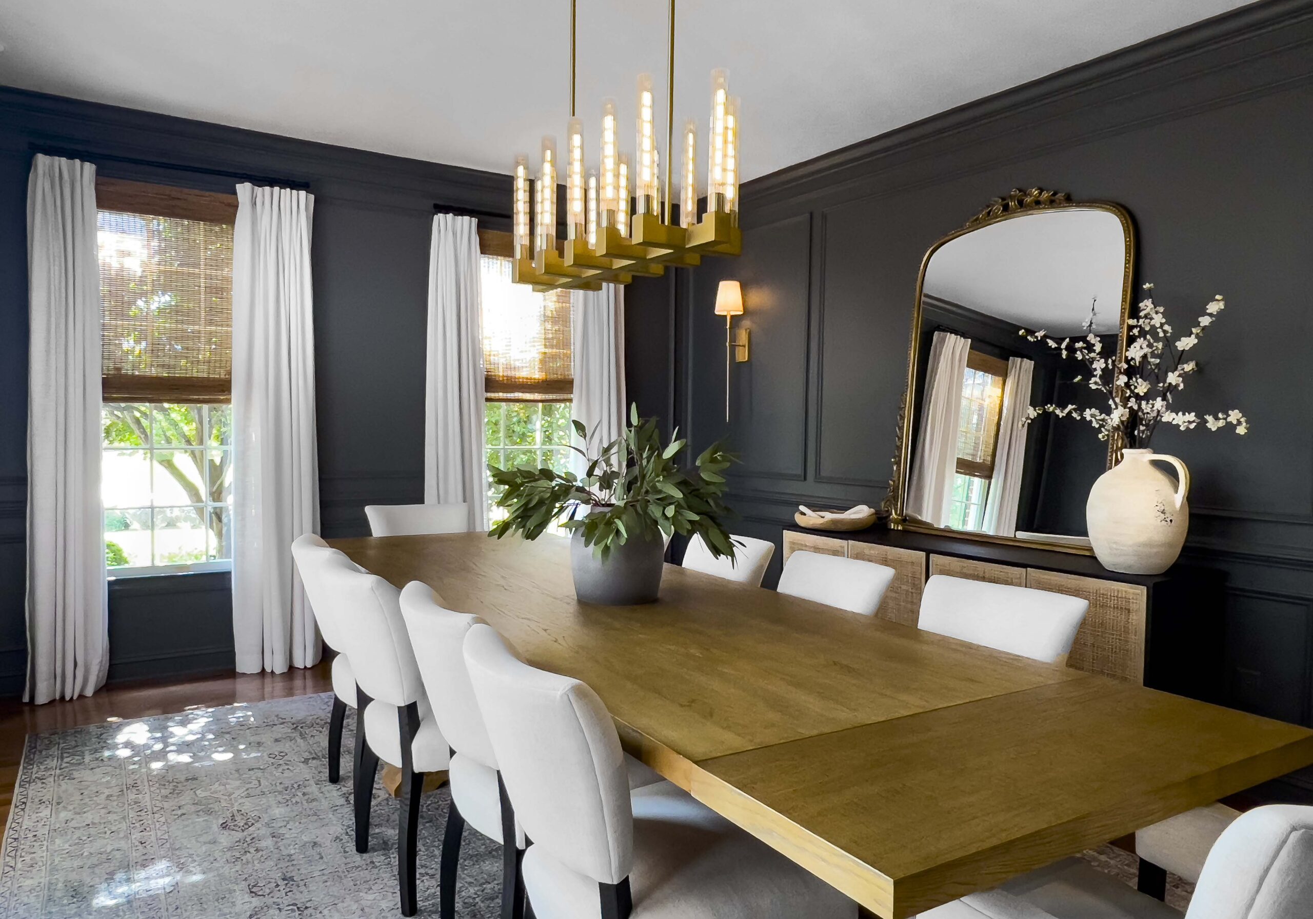 dining room with dark blue wall with moulding and neutral decor