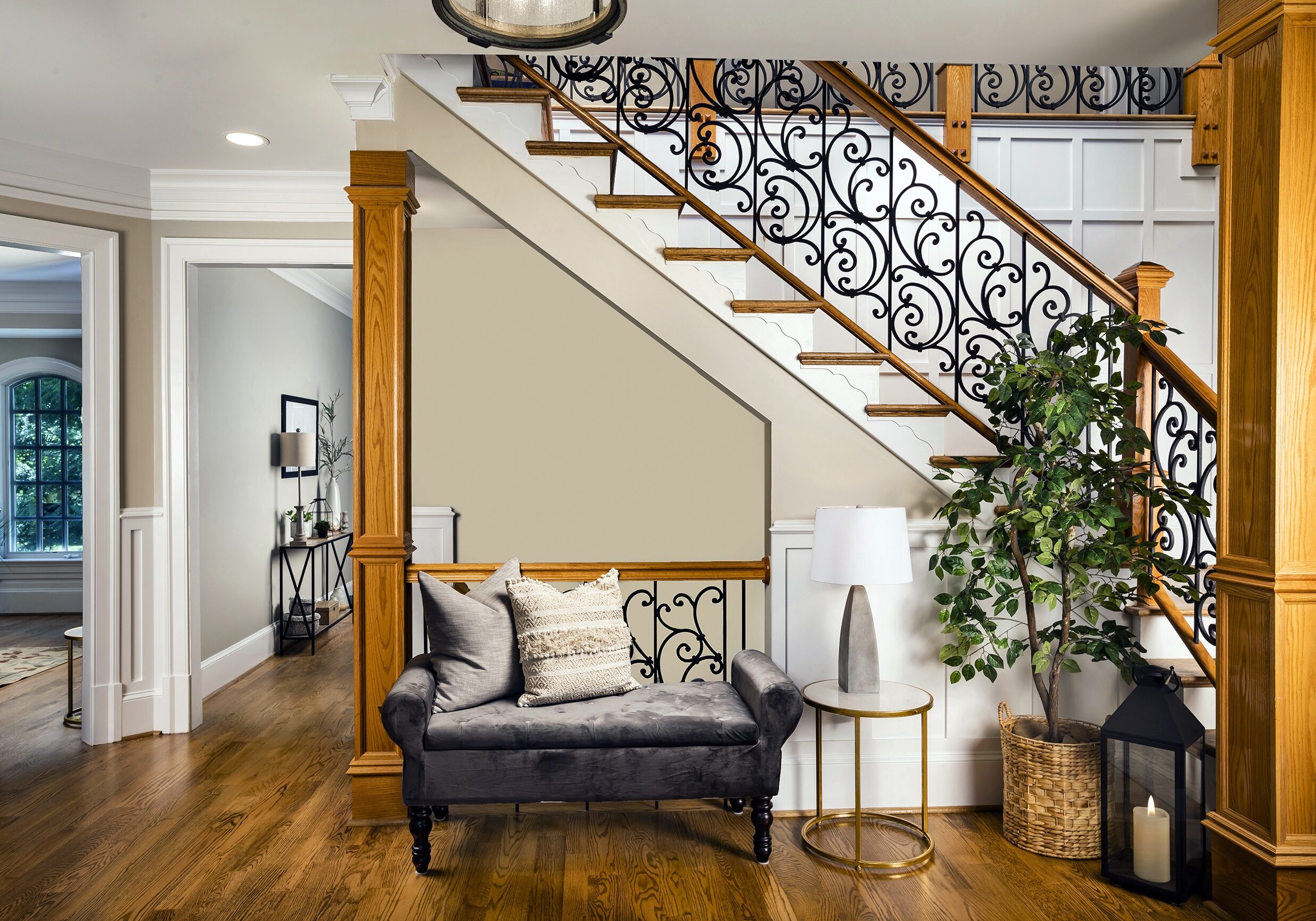 foyer with velvet bench and faux tree