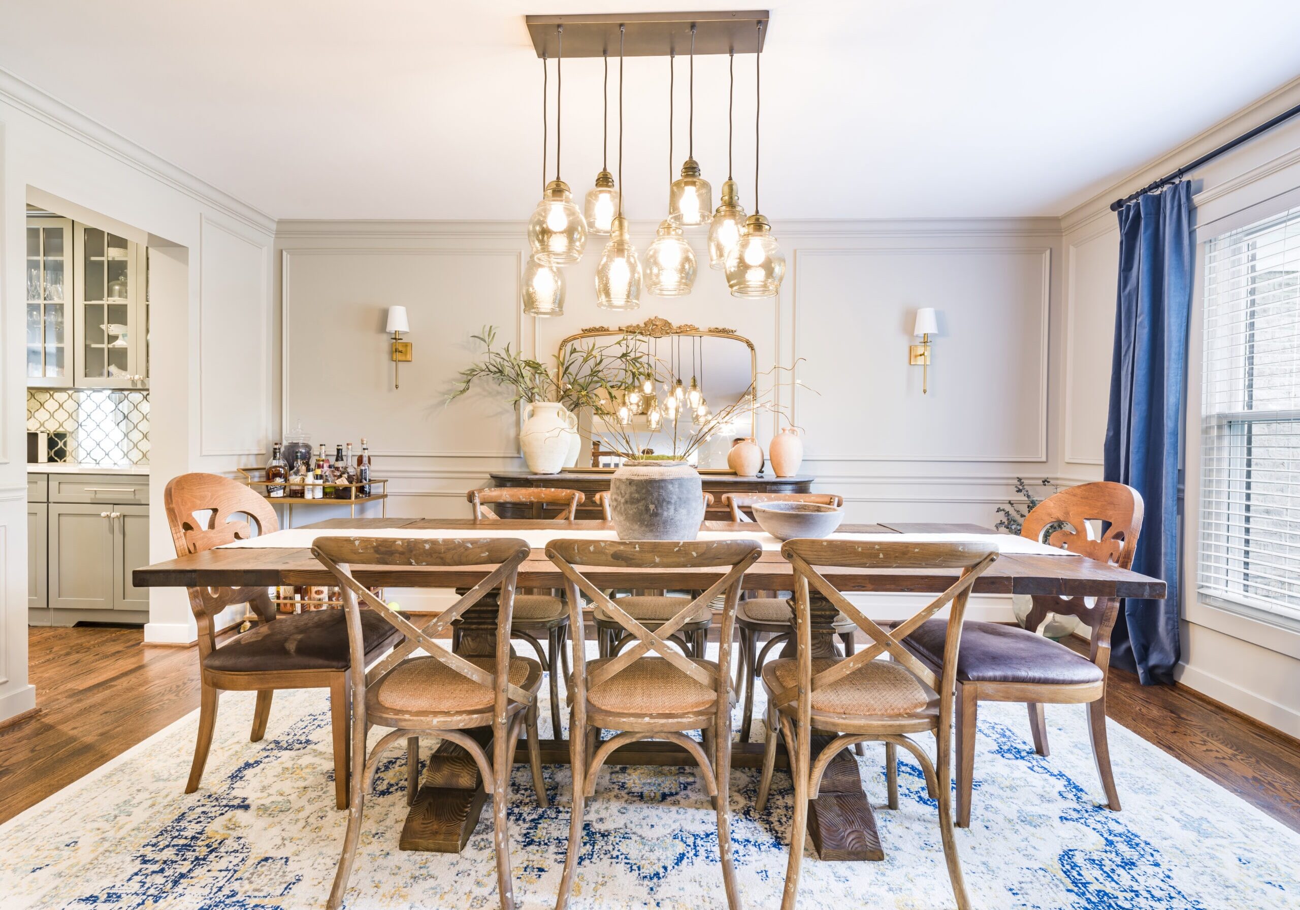 warm dining room with wall moulding and blue accents